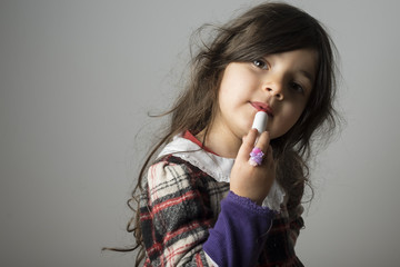 Small girl playing with makeup