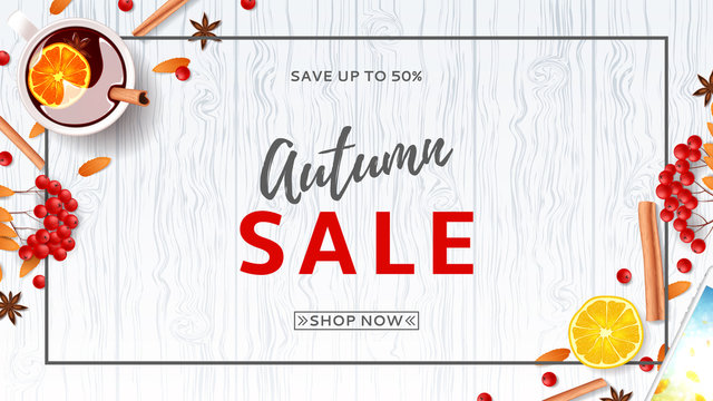 Beautiful web banner for autumn sale. Top view on composition with cup of mulled wine, rowan, cinnamon sticks on wooden texture. Vector illustration.