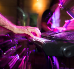 Musician plays keyboards in a rock band
