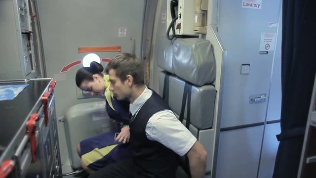 Cabin-crew take their sits aboard before taking off