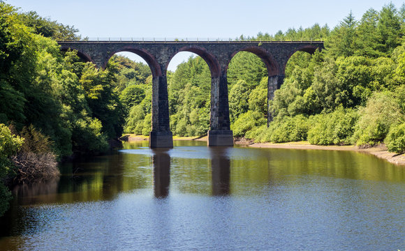 Old railway viaduct over Wayoh Reservoir on a beautiful summers afternoon, Bolton, Gtr Manchester, UK