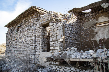 The ruins of an old house against the blue sky