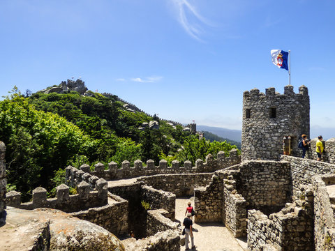 Walls of the Moorish Castle and Pena Palace in the background in Sintra, Portugal