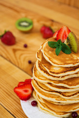 Delicious pancakes on wooden background