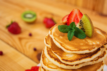 Delicious pancakes on wooden background