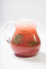 Homemade strawberry lemonade in a glass jug