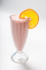 sweet fruit smoothie on a white background decorated with orange