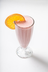 sweet fruit smoothie on a white background decorated with orange