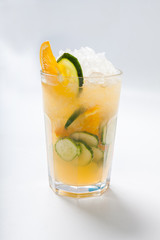 glass with orange cucumber refreshing drink, rustic style, selective focus