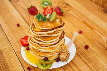 Delicious pancakes on wooden background