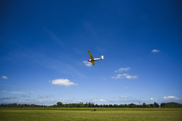 Small plane flying on the blue sky. Poland