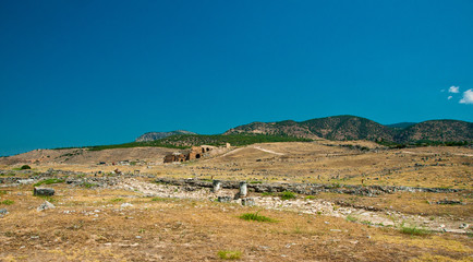 Fototapeta na wymiar Ruins and old buildings in Hierapolis ancient city adjacent to modern Pamukkale in Turkey