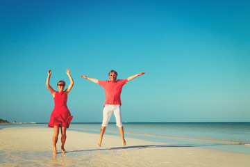 Happy couple enjoy tropical beach vacation