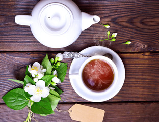 cup of black tea and a white brewer