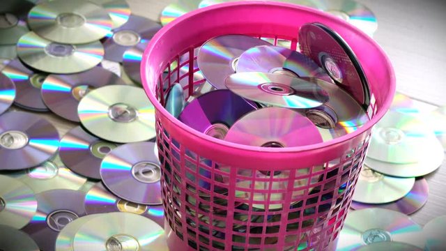 Dvd or cd Discs in Red Trash Bin and on the Floor