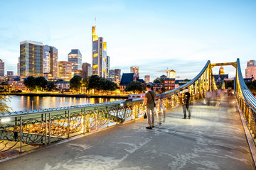 Beautiful cityscape view on the illuminated skyscrapers and bridge during the twilight in Frankfurt, Germany