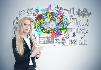 Blond woman with a copybook, brain cogs