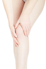Young woman touching her leg feeling knee pain isolated on white, clipping path
