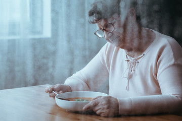 Woman eating soup - obrazy, fototapety, plakaty