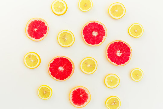 Citrus fruits pattern of lemon and grapefruit on white background. Flat lay, top view. Fruit's background