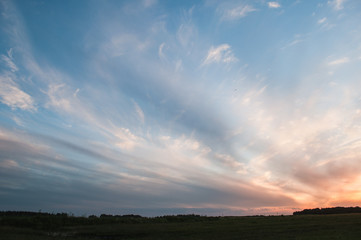 Dramatic sky at sunset, the contrast of Cirrus cloud shapes,