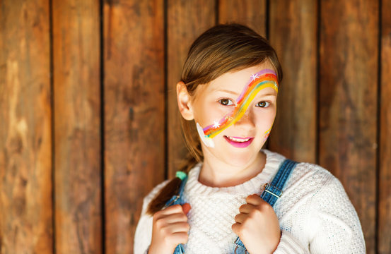 Close up portrait of adorable little kid girl with birthday party face painting