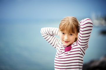 Outdoor close up portrait of young 8-9 year old girl