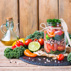 Healthy vegan salad in a mason jar with beans