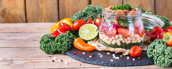 Healthy vegan salad in a mason jar with beans