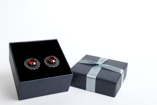 gift boxes for jewelry on a white background. top view. gift concept. Earrings with red stones.