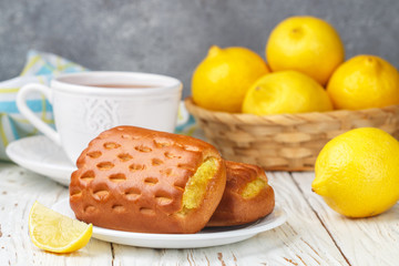 Traditionall Breakfast. Fresh homemade buns with lemon and tea. Rustic style. Selective focus