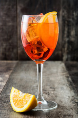 Aperol spritz cocktail in glass on wooden table
