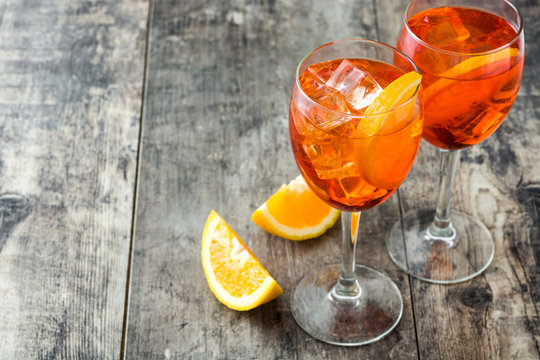 Aperol spritz cocktail in glass on wooden table
