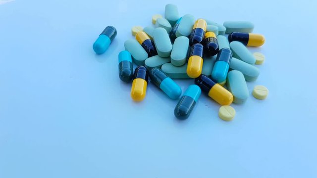 dolly shot medicine pills on blue background