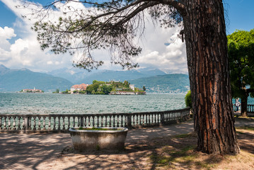 Fototapeta na wymiar View of the Isola Bella in the Lake Maggiore in Italy from a promenade along the coastline