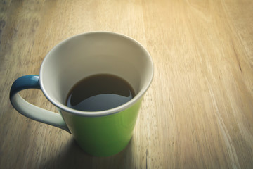 Obraz na płótnie Canvas Black coffee in green glass with morning