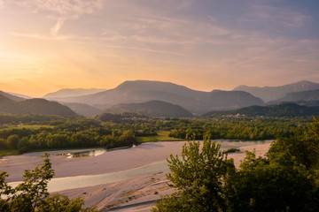 Fototapeta na wymiar Summer sunset lanscape over the river Tagliamento. View from the castle of Ragogna, Italy.