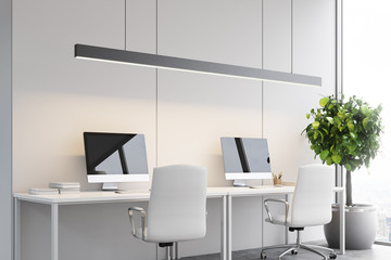 Two computers on tables, office, side