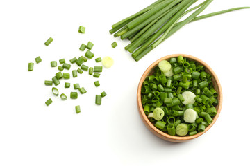 green onion in bowl isolated on white background. top view - obrazy, fototapety, plakaty