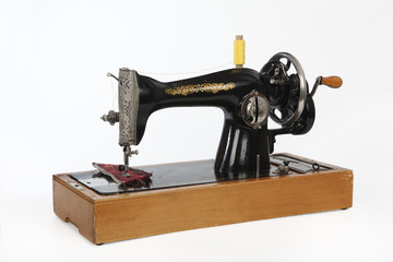 An old, hand sewing machine. Isolated, on white background