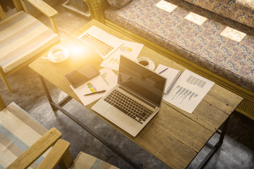 set of sofa with laptop ,paper chart ,coffee and coworking place in modern office,business concept.