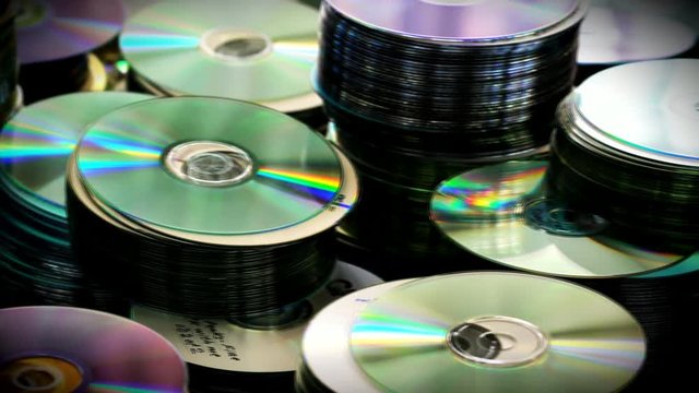 Compact Dvd or cd Discs Piles Standing on Table