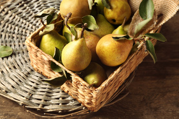 Fresh pears in wicker box closeup