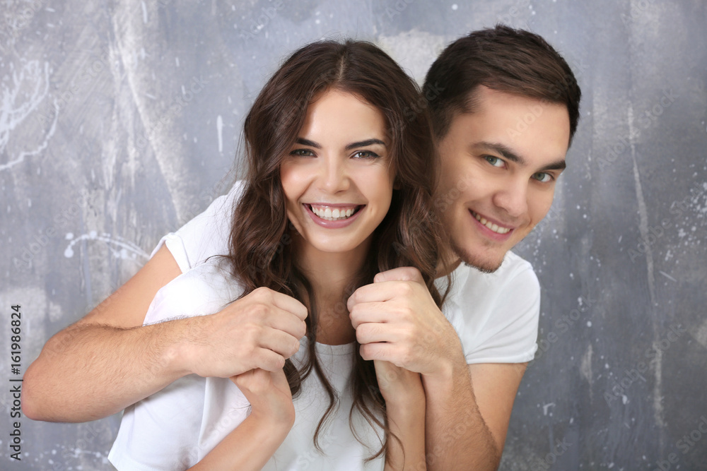 Sticker Beautiful young couple on grunge wall background