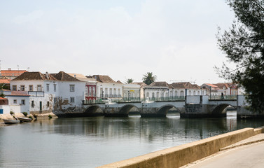 Fototapeta na wymiar medieval bridge over Gilao River in Tavira city