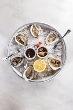 Oysters on half shell on white Marble