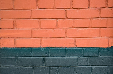 Background, texture of a brick wall, partly painted gray paint in the cracks