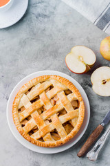 Popular American apple pie on gray table. Homemade classical friut tart. Copy space