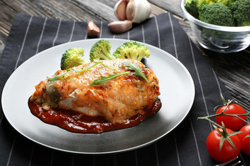Delicious chicken parmesan meal with broccoli on plate