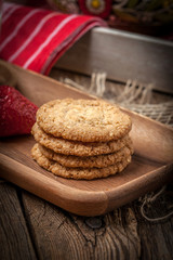 Stack of freshly baked oat biscuits in a bowl.